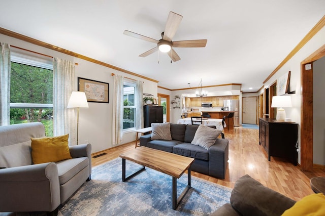 1055 Arcaro Dr, Columbus, OH 43230 - living area with crown molding, a ceiling fan, light wood finished floors, and baseboards