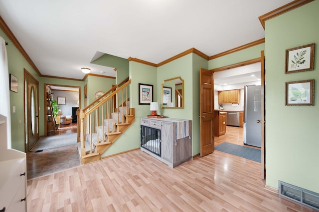 1055 Arcaro Dr, Columbus, OH 43230 - foyer with light wood-style flooring, stairs, baseboards, and crown molding