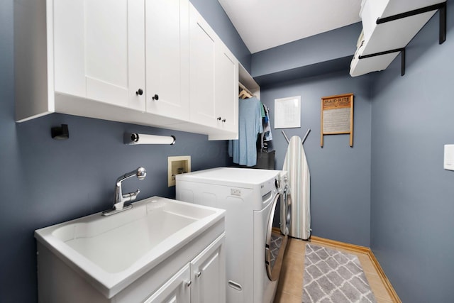 1055 Arcaro Dr, Columbus, OH 43230 - laundry area featuring cabinet space, washing machine and clothes dryer, light tile patterned floors, and baseboards