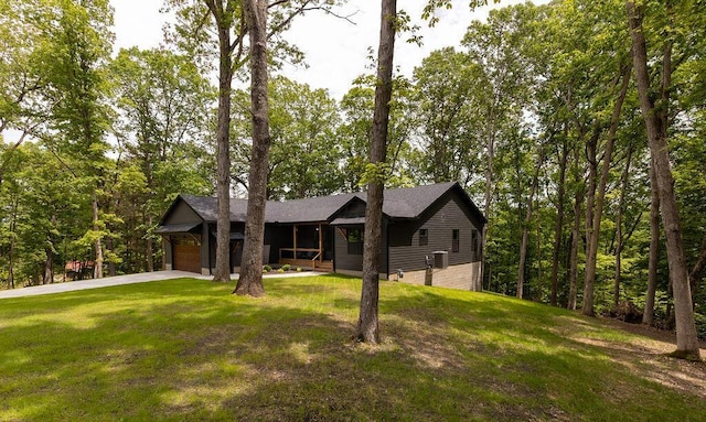 21650 Lake Rd, Glouster, OH 45732 - view of front facade featuring a front yard, a garage, concrete driveway, and covered porch