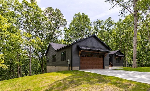 21650 Lake Rd, Glouster, OH 45732 - view of front facade with an attached garage, concrete driveway, and a front yard
