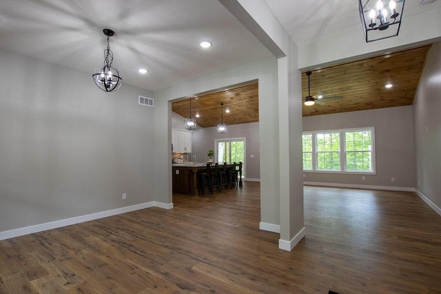 21650 Lake Rd, Glouster, OH 45732 - living area with a chandelier, vaulted ceiling, baseboards, dark wood-type flooring, and recessed lighting