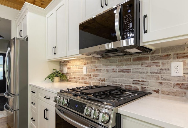 21650 Lake Rd, Glouster, OH 45732 - kitchen featuring stainless steel appliances, tasteful backsplash, white cabinetry, and light countertops