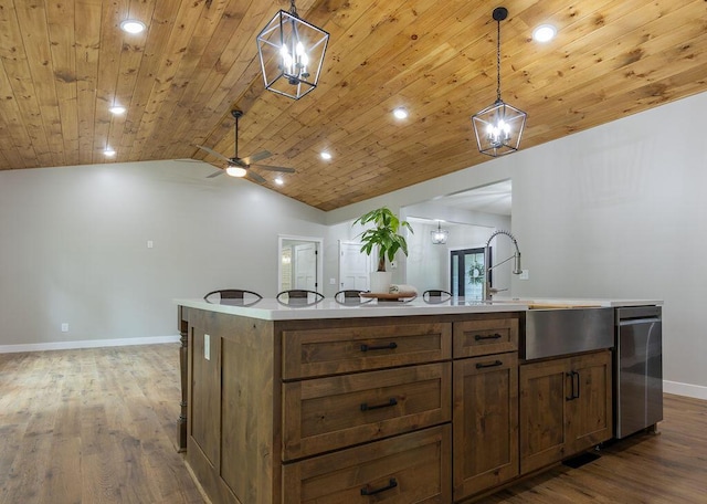 21650 Lake Rd, Glouster, OH 45732 - kitchen featuring baseboards, vaulted ceiling, wood finished floors, a sink, and light countertops