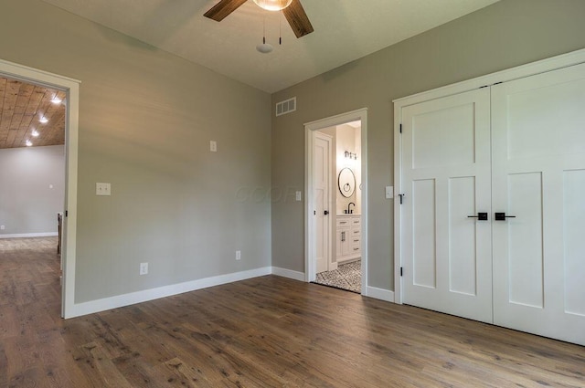 21650 Lake Rd, Glouster, OH 45732 - unfurnished bedroom featuring wood finished floors, baseboards, ensuite bath, a sink, and ceiling fan
