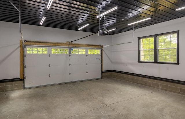 21650 Lake Rd, Glouster, OH 45732 - garage featuring a garage door opener and concrete block wall