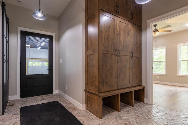 21650 Lake Rd, Glouster, OH 45732 - mudroom featuring baseboards, ceiling fan, and a barn door