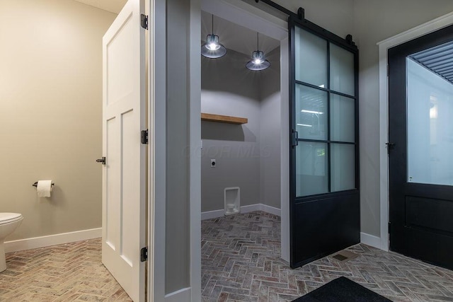 21650 Lake Rd, Glouster, OH 45732 - bathroom with toilet, brick flooring, and baseboards