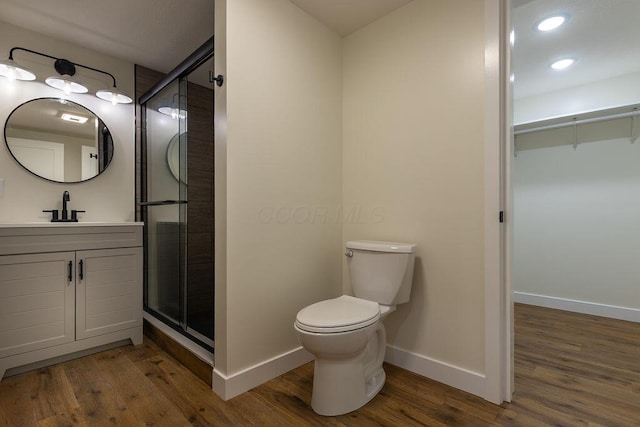 21650 Lake Rd, Glouster, OH 45732 - bathroom featuring baseboards, wood finished floors, vanity, a stall shower, and a spacious closet