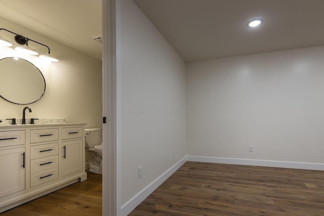 21650 Lake Rd, Glouster, OH 45732 - bathroom featuring vanity, toilet, wood finished floors, baseboards, and recessed lighting