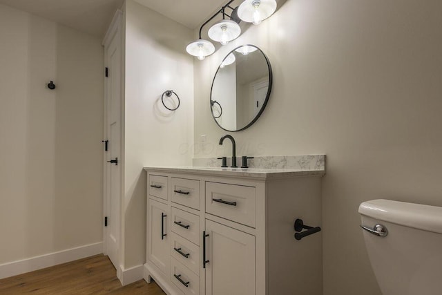 21650 Lake Rd, Glouster, OH 45732 - bathroom with toilet, vanity, wood finished floors, and baseboards