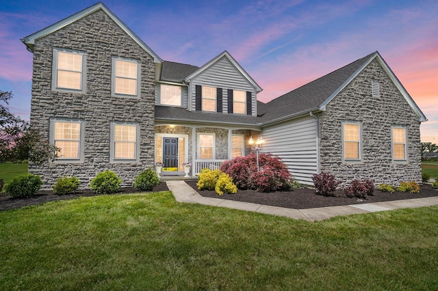 401 Warrenpoint Ln, Pataskala, OH 43062 - traditional home featuring stone siding, a front lawn, covered porch, and roof with shingles