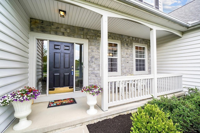 401 Warrenpoint Ln, Pataskala, OH 43062 - property entrance with covered porch, stone siding, and roof with shingles