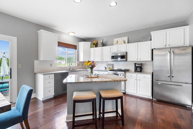 401 Warrenpoint Ln, Pataskala, OH 43062 - kitchen featuring stainless steel appliances, a sink, dark wood-type flooring, tasteful backsplash, and white cabinetry