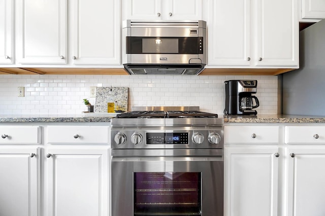 401 Warrenpoint Ln, Pataskala, OH 43062 - kitchen featuring appliances with stainless steel finishes, white cabinetry, backsplash, and light stone countertops