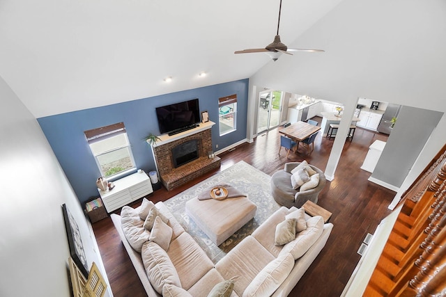401 Warrenpoint Ln, Pataskala, OH 43062 - living room with high vaulted ceiling, a brick fireplace, dark wood-style flooring, and a ceiling fan