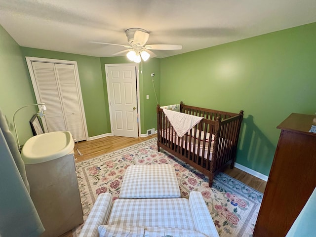 2010 S Main St, Findlay, OH 45840 - bedroom with wood finished floors, baseboards, a closet, and a ceiling fan