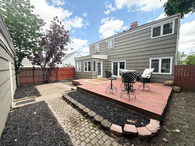 2010 S Main St, Findlay, OH 45840 - back of property featuring a wooden deck, a fenced backyard, and a chimney