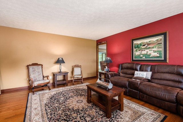 8263 Bennington Chapel Rd, Centerburg, OH 43011 - living area with wood finished floors, baseboards, and a textured ceiling