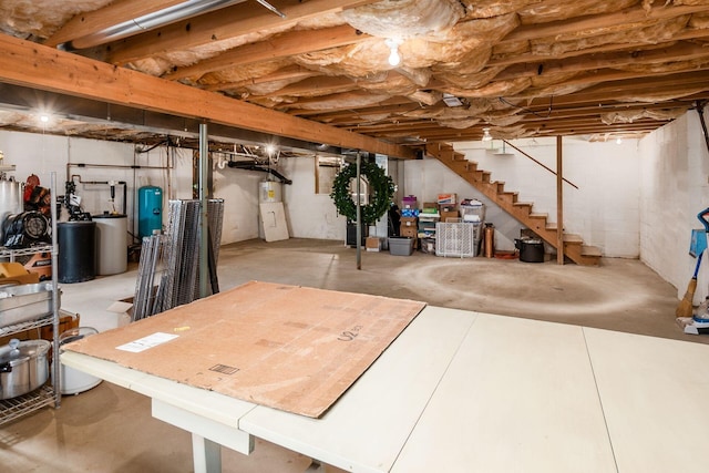 8263 Bennington Chapel Rd, Centerburg, OH 43011 - unfinished below grade area featuring a water softener, stairs, electric water heater, and a water pressure tank