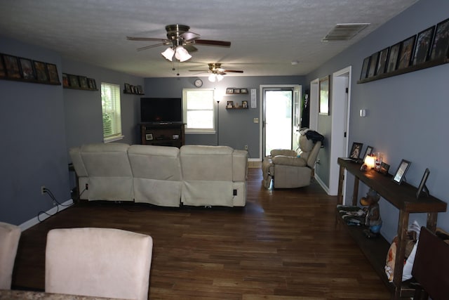 1131 Campbell St, Washington Court House, OH 43160 - living area featuring dark wood-type flooring, a ceiling fan, a textured ceiling, and baseboards
