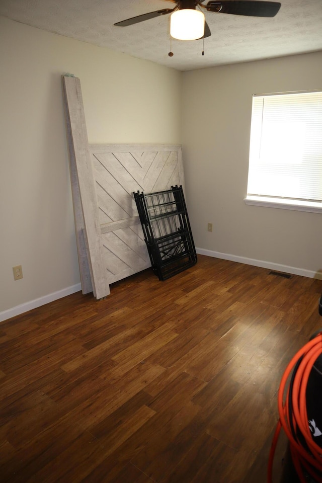1131 Campbell St, Washington Court House, OH 43160 - unfurnished bedroom with wood finished floors, baseboards, and a ceiling fan