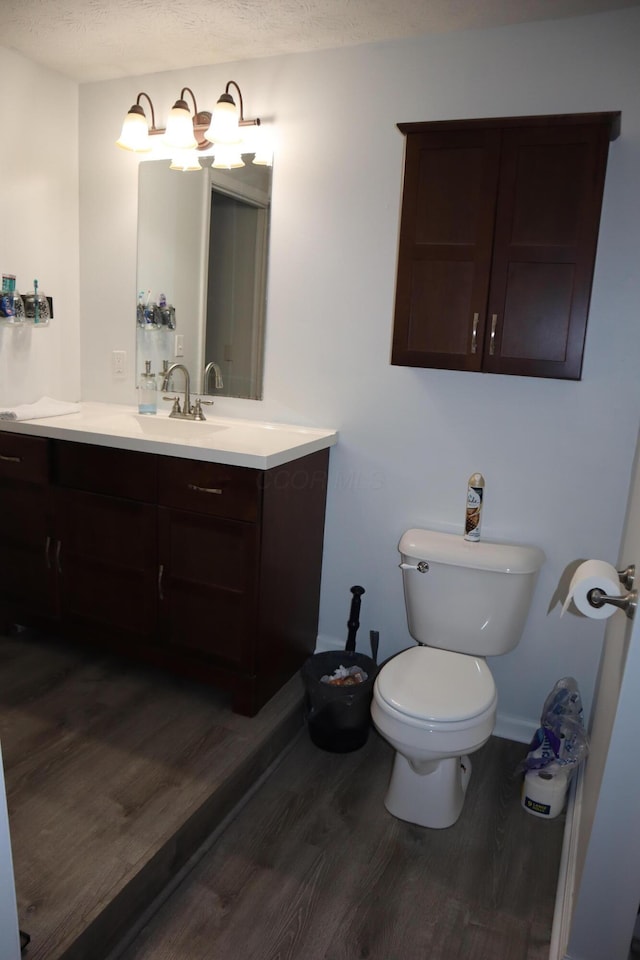1131 Campbell St, Washington Court House, OH 43160 - bathroom with wood finished floors, vanity, toilet, and baseboards
