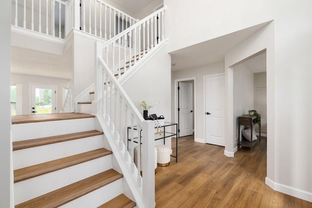 6377 Dietz Dr, Canal Winchester, OH 43110 - stairs featuring wood finished floors, baseboards, and a towering ceiling