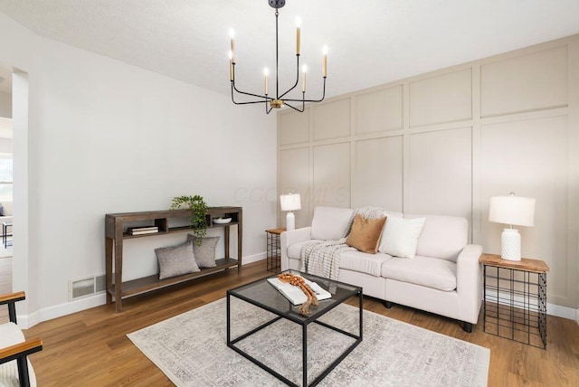 6377 Dietz Dr, Canal Winchester, OH 43110 - living room with a chandelier, baseboards, and wood finished floors