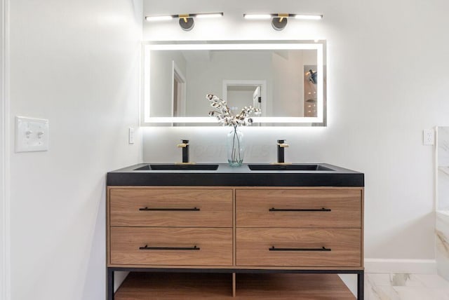 6377 Dietz Dr, Canal Winchester, OH 43110 - bathroom featuring double vanity, marble finish floors, and baseboards