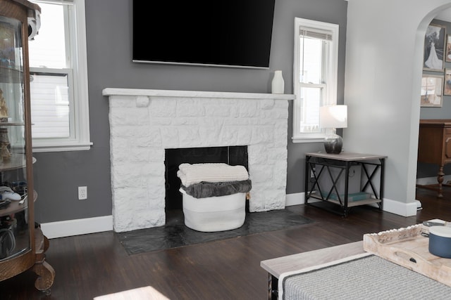 41 N Westmoor Ave, Columbus, OH 43204 - living area with wood finished floors, baseboards, a fireplace, and arched walkways