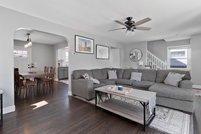 41 N Westmoor Ave, Columbus, OH 43204 - living area featuring arched walkways, dark wood finished floors, a ceiling fan, stairway, and a chandelier