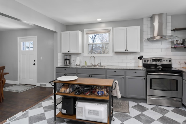 41 N Westmoor Ave, Columbus, OH 43204 - kitchen featuring stainless steel range with electric cooktop, a sink, wall chimney exhaust hood, gray cabinetry, and healthy amount of natural light