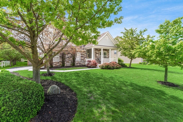 6458 Tallman Ct, Canal Winchester, OH 43110 - view of front of home featuring stone siding, a front yard, and covered porch