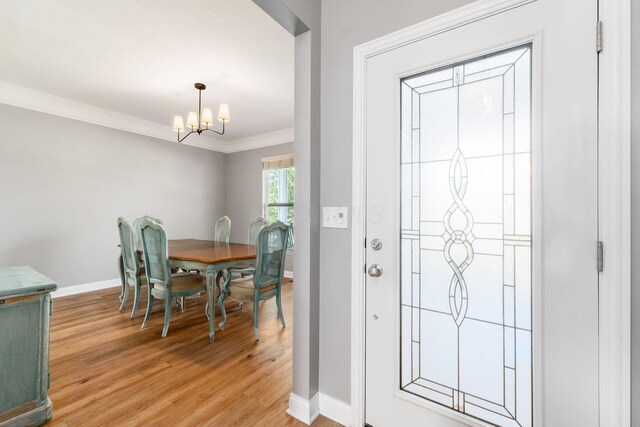 6458 Tallman Ct, Canal Winchester, OH 43110 - foyer featuring a chandelier, light wood-style flooring, baseboards, and crown molding