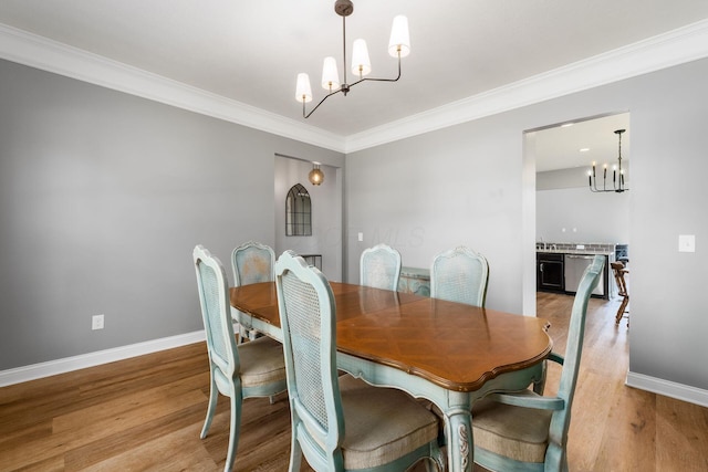 6458 Tallman Ct, Canal Winchester, OH 43110 - dining space featuring a chandelier, ornamental molding, light wood-style flooring, and baseboards