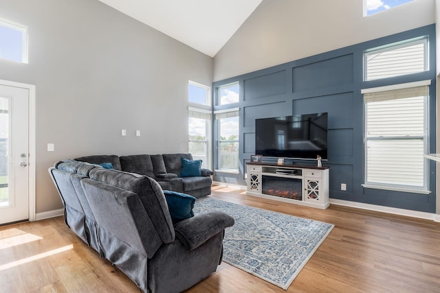 6458 Tallman Ct, Canal Winchester, OH 43110 - living room with high vaulted ceiling, light wood finished floors, and baseboards