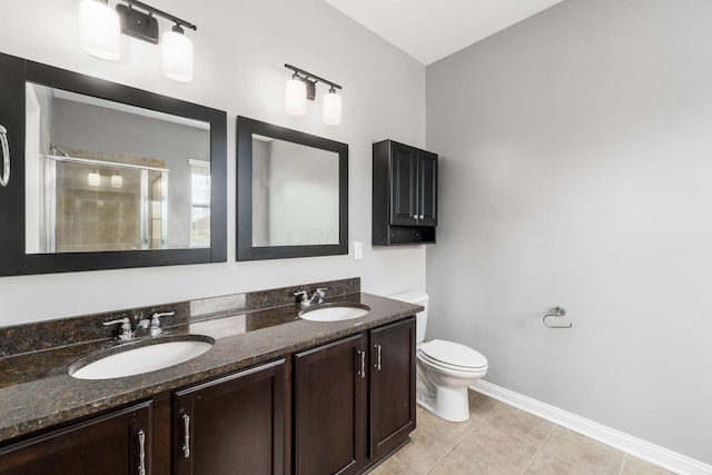 6458 Tallman Ct, Canal Winchester, OH 43110 - bathroom featuring toilet, a shower stall, double vanity, tile patterned flooring, and baseboards