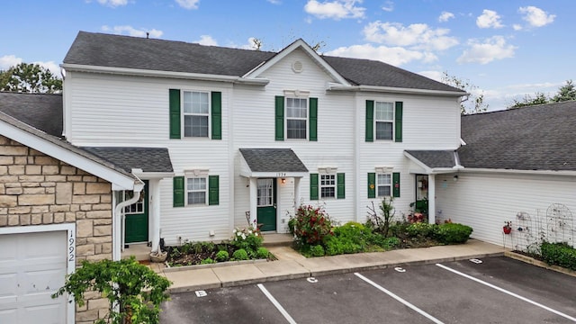 1994 Hoadley Dr Unit 7C, Columbus, OH 43228 - view of property with roof with shingles, stone siding, and uncovered parking