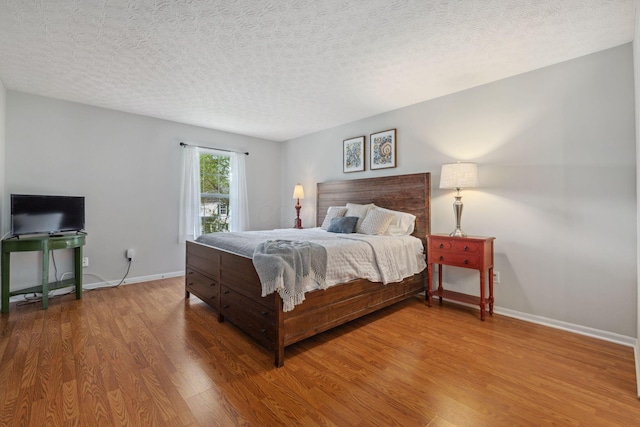 1994 Hoadley Dr Unit 7C, Columbus, OH 43228 - bedroom with wood finished floors, baseboards, and a textured ceiling