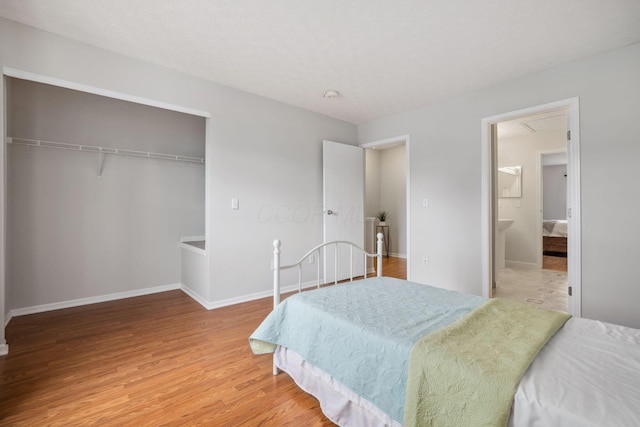 1994 Hoadley Dr Unit 7C, Columbus, OH 43228 - bedroom featuring light wood-style flooring, baseboards, a closet, and ensuite bathroom