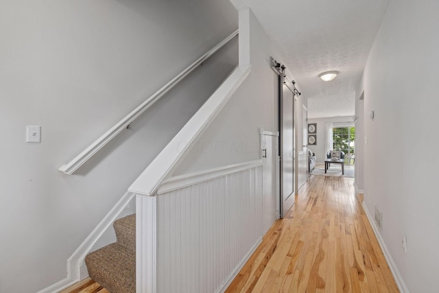 1994 Hoadley Dr Unit 7C, Columbus, OH 43228 - corridor featuring stairs, light wood-style floors, and a textured ceiling