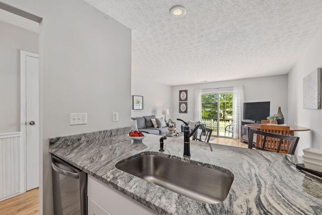 1994 Hoadley Dr Unit 7C, Columbus, OH 43228 - kitchen with a sink, open floor plan, light wood-type flooring, light stone counters, and a textured ceiling