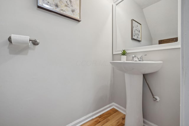1994 Hoadley Dr Unit 7C, Columbus, OH 43228 - bathroom with wood finished floors, baseboards, a sink, and vaulted ceiling