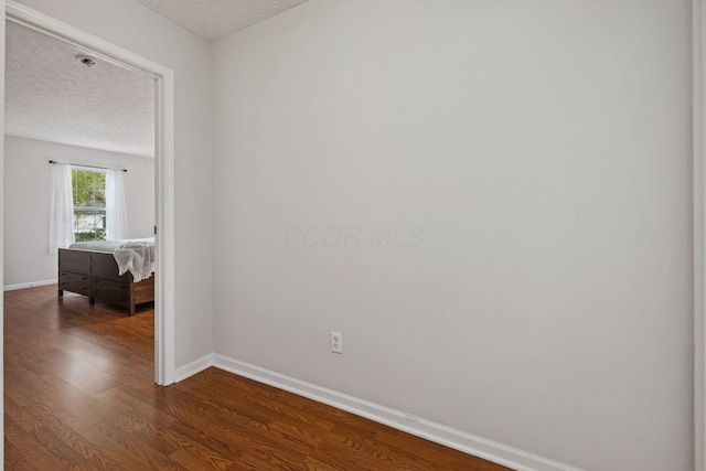 1994 Hoadley Dr Unit 7C, Columbus, OH 43228 - empty room with a textured ceiling, baseboards, and dark wood finished floors