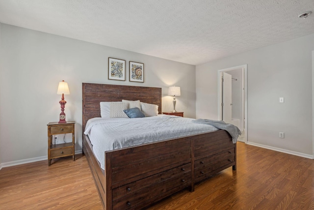 1994 Hoadley Dr Unit 7C, Columbus, OH 43228 - bedroom featuring light wood-type flooring, baseboards, and a textured ceiling