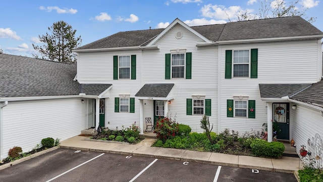 1994 Hoadley Dr Unit 7C, Columbus, OH 43228 - view of property with uncovered parking and a shingled roof