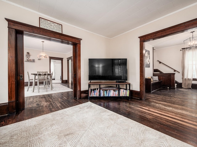 154 Montgomery Blvd, New Concord, OH 43762 - living area with hardwood / wood-style flooring, a chandelier, crown molding, stairs, and baseboards