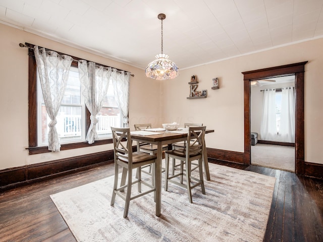 154 Montgomery Blvd, New Concord, OH 43762 - dining area with healthy amount of natural light, ornamental molding, wood-type flooring, baseboards, and a chandelier