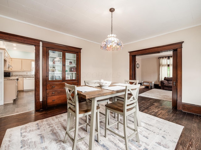 154 Montgomery Blvd, New Concord, OH 43762 - dining space with dark wood-type flooring, a chandelier, and ornamental molding